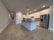 Open-concept kitchen features a large island, stainless steel appliances, and modern finishes at 8706 Arrow Creek Dr, Parrish, FL 34219