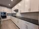 Bright kitchen boasts stainless steel appliances, white cabinets, and a sleek countertop at 8706 Arrow Creek Dr, Parrish, FL 34219