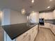 Modern kitchen with stone countertops, stainless steel appliances, and pendant lighting at 8706 Arrow Creek Dr, Parrish, FL 34219