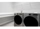 Well-lit laundry room featuring a sink, washer, dryer, wire rack, and a countertop at 8706 Arrow Creek Dr, Parrish, FL 34219