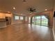 Open-concept living room with stainless steel appliances and serene outdoor views at 8706 Arrow Creek Dr, Parrish, FL 34219