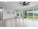 An open-concept living area featuring wood-look floors and sliding doors leading to outdoor space at 8706 Arrow Creek Dr, Parrish, FL 34219
