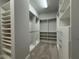Large walk-in closet featuring custom shelving, hanging racks, and ample storage space, perfect for organization at 8706 Arrow Creek Dr, Parrish, FL 34219