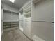 Well-organized walk-in closet with shelving, hanging rods, and built-in storage drawers for optimal storage at 8706 Arrow Creek Dr, Parrish, FL 34219