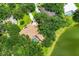 Aerial view showcasing a home with a screened pool surrounded by mature trees and greenery at 8717 Misty Creek Dr, Sarasota, FL 34241