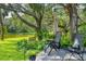 Lounge in luxury with comfortable deck chairs, surrounded by mature trees and lake views at 8717 Misty Creek Dr, Sarasota, FL 34241