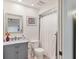 Charming bathroom features a marble-top vanity, toilet, and shower with white shower curtain at 8717 Misty Creek Dr, Sarasota, FL 34241