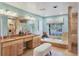 Beautiful bathroom with dual sinks, vanity, bathtub, shower, and natural light at 8717 Misty Creek Dr, Sarasota, FL 34241