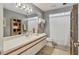 Neutral-colored bathroom featuring an extended vanity, shower with curtains, and decorative shelving at 8717 Misty Creek Dr, Sarasota, FL 34241