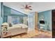 Bright bedroom featuring a workstation, a bed with light blue comforter, and sliding glass doors to the lanai at 8717 Misty Creek Dr, Sarasota, FL 34241