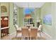 Bright dining room with a large window, stylish decor, and ample natural light at 8717 Misty Creek Dr, Sarasota, FL 34241