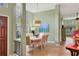 Inviting dining room with a large window, stylish decor, and ample natural light at 8717 Misty Creek Dr, Sarasota, FL 34241