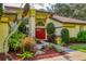 Charming front entrance with a red double door and beautifully landscaped surroundings at 8717 Misty Creek Dr, Sarasota, FL 34241