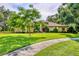 Charming home with a lush green lawn and beautiful landscaping at 8717 Misty Creek Dr, Sarasota, FL 34241