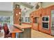 Spacious kitchen featuring a large island, custom cabinetry, and stainless steel appliances at 8717 Misty Creek Dr, Sarasota, FL 34241