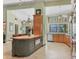 Spacious kitchen with a large island, custom cabinetry, stainless steel appliances, and lots of natural light at 8717 Misty Creek Dr, Sarasota, FL 34241