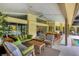 Expansive covered patio featuring comfortable seating, dining area, and access to a pool at 8717 Misty Creek Dr, Sarasota, FL 34241