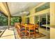 Spacious outdoor patio with dining table, chairs, and screened-in sitting area at 8717 Misty Creek Dr, Sarasota, FL 34241