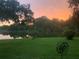 Gorgeous sunset views over the tranquil lake in the backyard at 8717 Misty Creek Dr, Sarasota, FL 34241