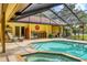 Beautiful screened-in pool area with outdoor kitchen and ample seating for entertaining at 8717 Misty Creek Dr, Sarasota, FL 34241