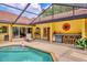 Sparkling pool and patio area featuring a built-in outdoor kitchen and inviting seating at 8717 Misty Creek Dr, Sarasota, FL 34241