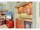 Wet bar has custom cabinets, granite countertop, wine fridge, and glass shelving at 8717 Misty Creek Dr, Sarasota, FL 34241