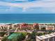 Beautiful aerial view of beachfront condos with a tennis court and the Gulf of Mexico at 8750 Midnight Pass Rd # 501, Sarasota, FL 34242