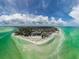 Panoramic aerial view of a beach community with white sands and clear turquoise waters at 8750 Midnight Pass Rd # 501, Sarasota, FL 34242