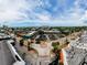 Aerial view of a beachside town with palm trees, shops, and ocean views at 8750 Midnight Pass Rd # 501, Sarasota, FL 34242