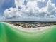 Wide aerial shot of a beach community, showcasing sandy shores and clear waters by the Gulf at 8750 Midnight Pass Rd # 501, Sarasota, FL 34242