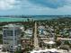 Scenic aerial shot of a coastal city with palm-lined streets and views of the ocean at 8750 Midnight Pass Rd # 501, Sarasota, FL 34242