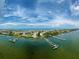 Aerial view of waterfront community with docks and a marina on a sunny day at 8750 Midnight Pass Rd # 501, Sarasota, FL 34242