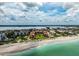Aerial view of beachfront condo community with lush landscaping and stunning ocean views, highlighting a vibrant coastal lifestyle at 8750 Midnight Pass Rd # 501, Sarasota, FL 34242