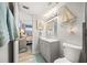Charming bathroom features gray vanity, updated lighting, and nautical decor at 8750 Midnight Pass Rd # 501, Sarasota, FL 34242