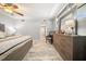Well-lit bedroom with a ceiling fan, dresser, and modern decor at 8750 Midnight Pass Rd # 501, Sarasota, FL 34242