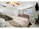 Bedroom with large bed, window, TV, and neutral decor at 8750 Midnight Pass Rd # 501, Sarasota, FL 34242