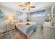 Coastal bedroom with queen bed, wood ceiling fan, two windows, and marine decor at 8750 Midnight Pass Rd # 501, Sarasota, FL 34242