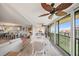 Bright dining area with coastal decor, open to the living space and showcasing access to a balcony with ocean views at 8750 Midnight Pass Rd # 501, Sarasota, FL 34242