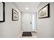 Entryway with beach themed artwork and a light wood floor at 8750 Midnight Pass Rd # 501, Sarasota, FL 34242