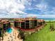 Exterior aerial showcasing the condo building, its pool, and nearby beach access, ideal for vacation living at 8750 Midnight Pass Rd # 501, Sarasota, FL 34242