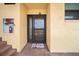 Exterior front door featuring a welcome mat and building number at 8750 Midnight Pass Rd # 501, Sarasota, FL 34242