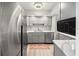 Updated kitchen features stainless steel appliances, white cabinets, and recessed lighting at 8750 Midnight Pass Rd # 501, Sarasota, FL 34242