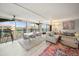 Bright living room features a balcony with views, wood floors, and comfortable seating at 8750 Midnight Pass Rd # 501, Sarasota, FL 34242