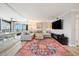 Cozy living room with a large sectional sofa, stylish rug, and access to a balcony at 8750 Midnight Pass Rd # 501, Sarasota, FL 34242