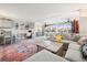 Bright and airy living room featuring a comfortable sectional sofa, stylish decor, and a large window with scenic views at 8750 Midnight Pass Rd # 501, Sarasota, FL 34242
