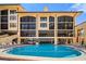Community pool with plenty of seating and an outdoor shower for rinsing off after a swim at 8750 Midnight Pass Rd # 501, Sarasota, FL 34242