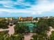 Aerial view of tennis courts within a lush community setting, offering recreational opportunities and scenic views at 8750 Midnight Pass Rd # 501, Sarasota, FL 34242