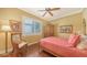 Cozy bedroom with hardwood floors, ceiling fan and closet, accentuated by warm paint and natural light at 8832 Enclave Ct, Sarasota, FL 34238