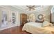 Relaxing bedroom with hardwood floors, tray ceiling, and access to a private outdoor space at 8832 Enclave Ct, Sarasota, FL 34238