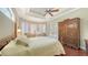 Charming bedroom features hardwood floors, tray ceiling, and a cozy sitting area by the windows at 8832 Enclave Ct, Sarasota, FL 34238